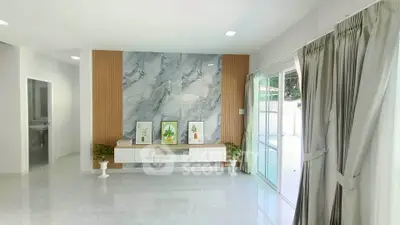 Bright and modern living room with marble accent wall and sliding glass doors.