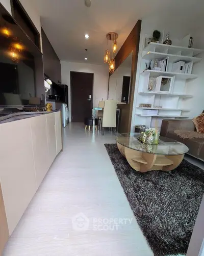 Modern living room with stylish decor and open kitchen layout in a contemporary apartment.