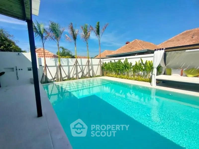 Luxurious private pool with tropical landscaping and elegant cabana in a serene villa setting.