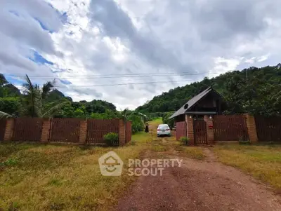 Charming countryside property with wooden fence and lush greenery
