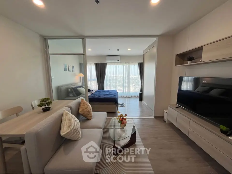 Modern open-plan living room with stylish decor and large windows offering a stunning view.