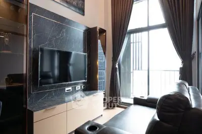 Luxurious living room with modern decor and large windows offering natural light and stunning views.