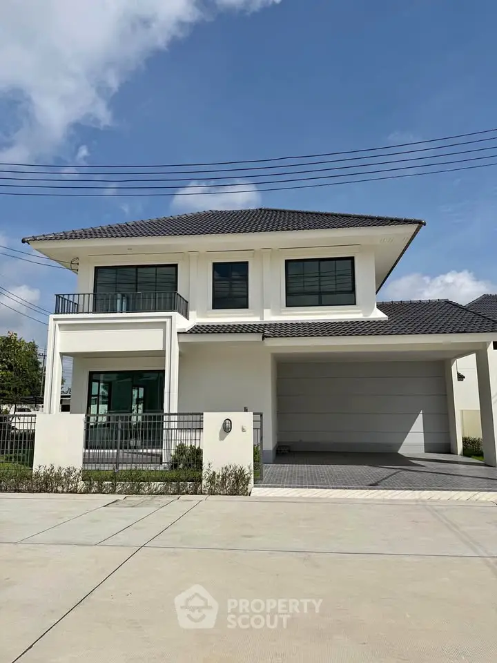 Modern two-story house with sleek design and spacious driveway