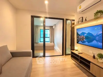 Modern living room with sleek design, featuring a cozy sofa, wall-mounted TV, and view into a stylish bedroom.