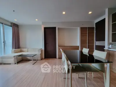 Spacious modern living room with elegant dining area and natural light