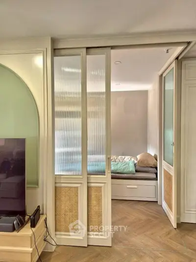 Stylish bedroom with sliding doors and cozy bed in modern apartment