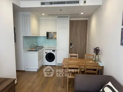 Modern compact kitchen with integrated appliances and cozy dining area