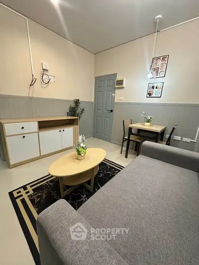 Cozy living room with modern furniture and stylish decor in a compact apartment.