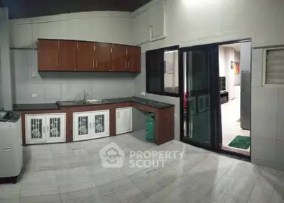 Spacious kitchen with modern cabinets and open layout, perfect for culinary enthusiasts.