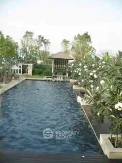 Luxurious outdoor pool surrounded by lush greenery and elegant landscaping