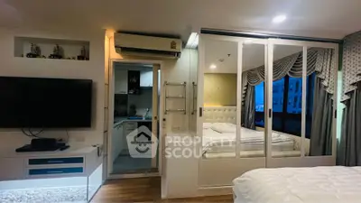 Modern studio apartment with open layout, featuring a cozy bedroom and compact kitchen.