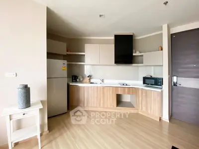 Modern kitchen with sleek cabinetry and appliances in a stylish apartment
