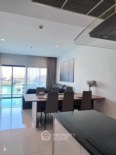 Modern living room with dining area and balcony view in luxury apartment