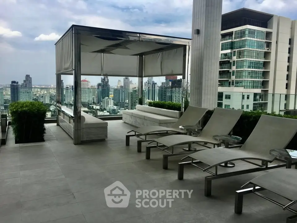 Luxurious rooftop terrace with stunning city views and modern lounge chairs.