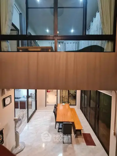 Spacious modern dining area with high ceiling and mezzanine view