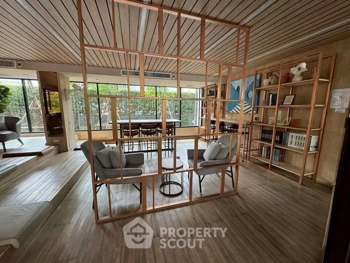 Modern open-plan living room with stylish wooden partition and natural light