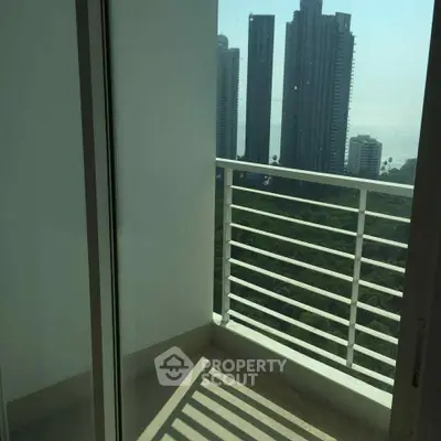 Modern apartment balcony with city skyline view, perfect for urban living.
