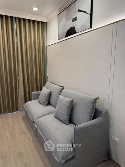 Modern living room with stylish gray sofa and elegant decor