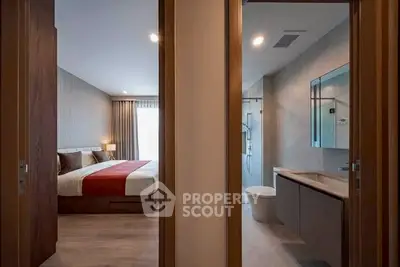 Modern bedroom and bathroom with sleek design and warm lighting
