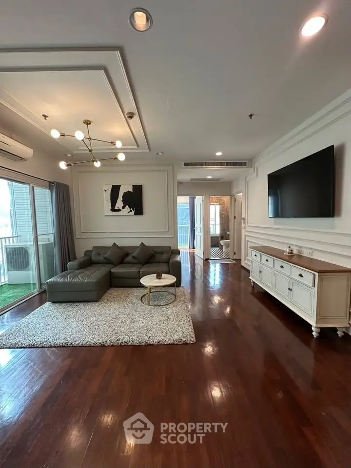 Spacious living room with modern decor and hardwood floors in luxury apartment