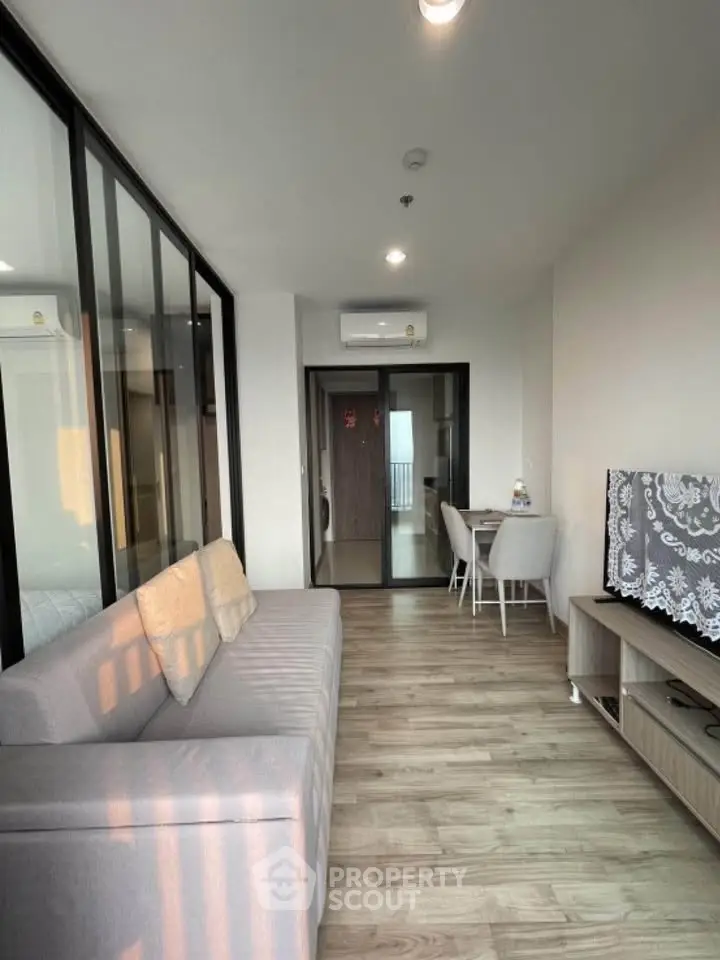 Modern living room with glass partition and cozy seating area
