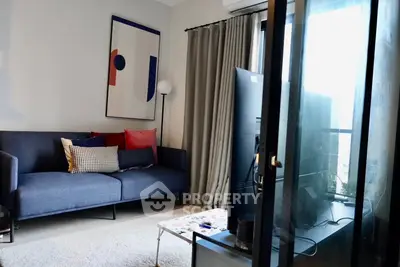 Modern living room with stylish decor and large window for natural light.