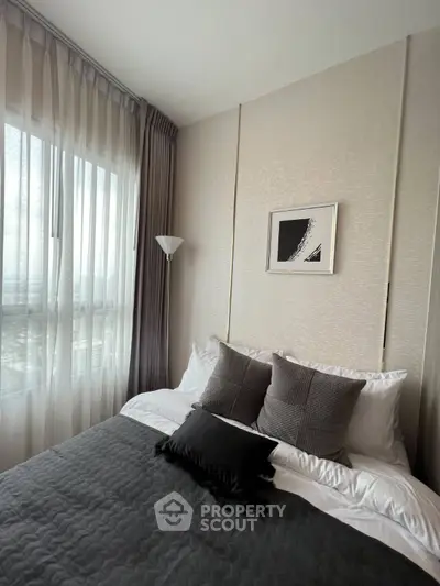 Modern bedroom with elegant decor and large window for natural light