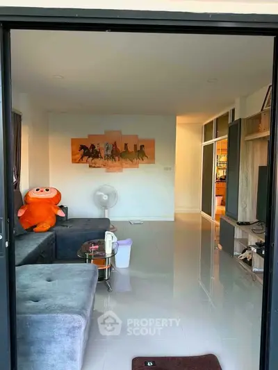 Spacious living room with modern decor and plush seating in a cozy apartment.