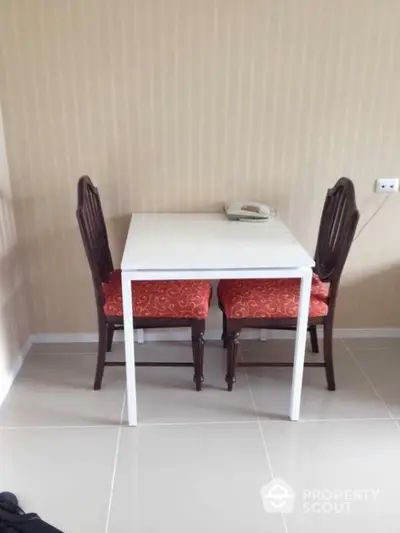 Cozy dining nook with elegant chairs and compact table in modern apartment