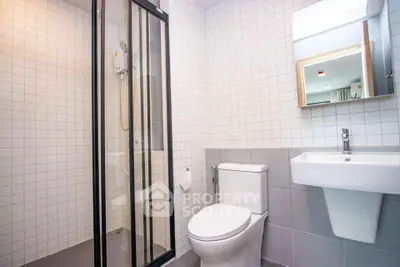Modern bathroom with sleek shower and contemporary fixtures in stylish apartment.