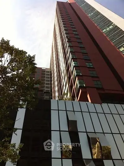 Stunning modern high-rise building with sleek architectural design and reflective glass facade.