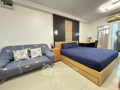 Modern bedroom with stylish decor and cozy seating area
