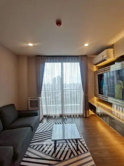 Modern living room with city view, stylish furniture, and natural light