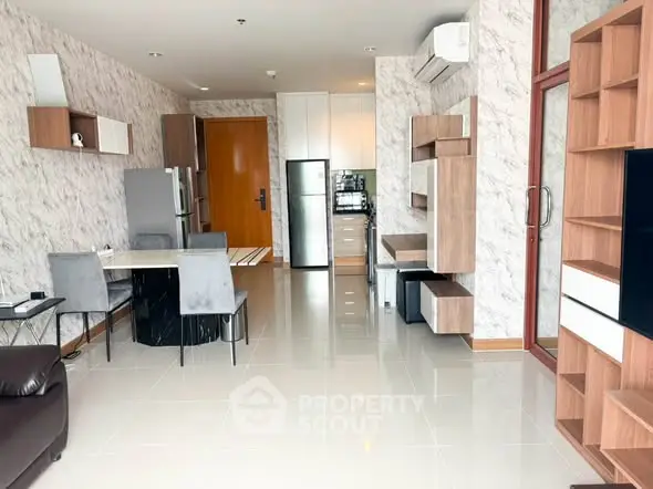 Modern open-plan living room with stylish furniture and sleek kitchen appliances.