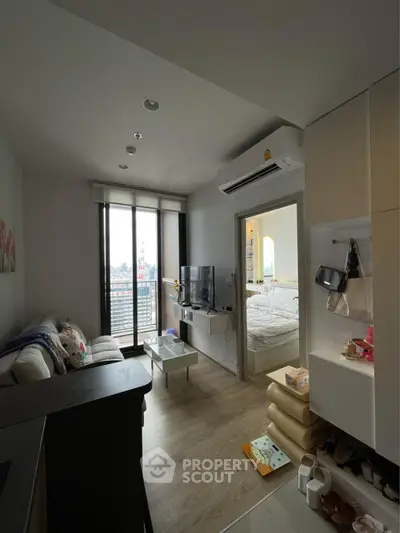 Modern apartment living room with balcony and bedroom view