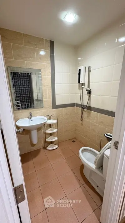 Modern bathroom with sleek fixtures and tiled walls in a contemporary home.