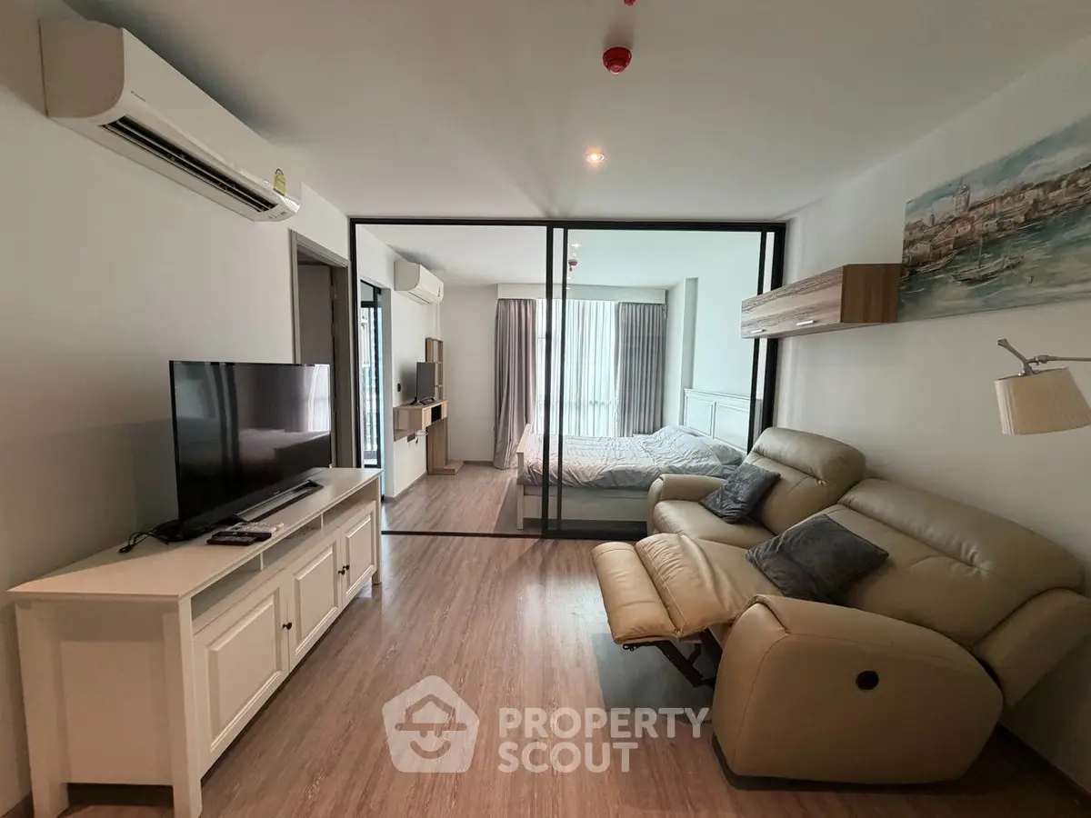 Modern living room with glass partition and cozy seating area