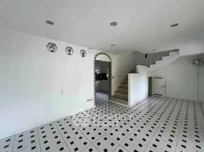Spacious interior with unique tiled flooring and staircase, ideal for modern living.