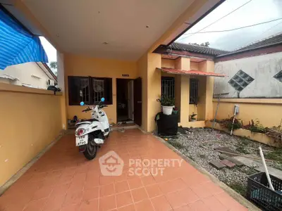 Charming single-story home with tiled patio and scooter parking, perfect for cozy living.