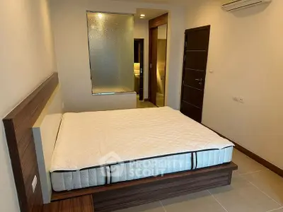 Modern bedroom with stylish wooden bed frame and air conditioning in a cozy apartment.