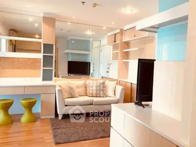 Modern living room with stylish furniture and built-in shelves, featuring a cozy sofa and flat-screen TV.