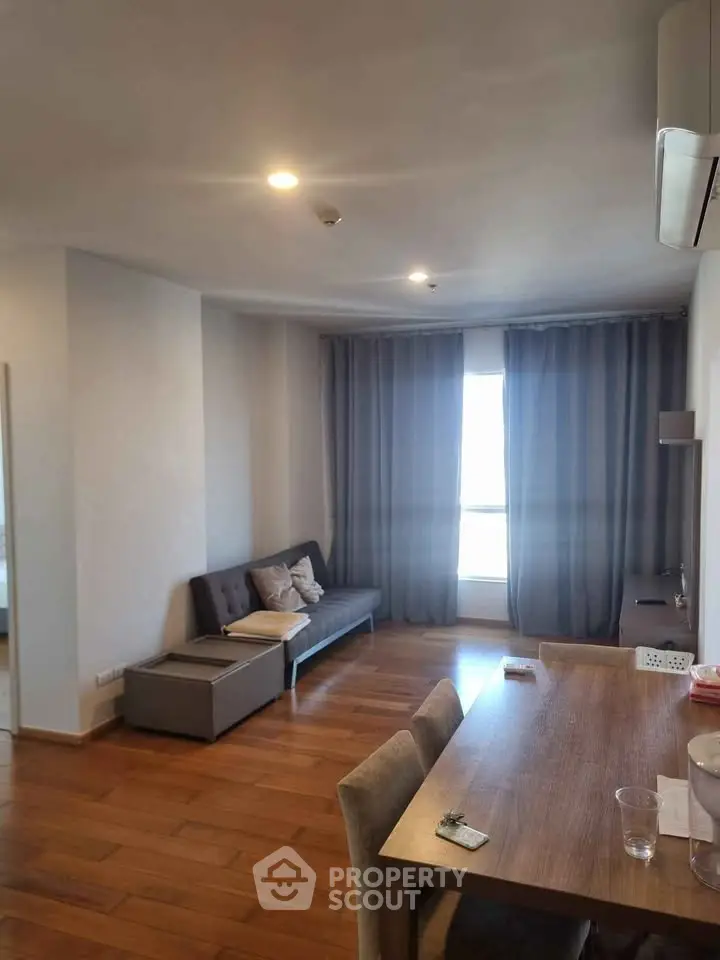 Spacious living room with modern decor and large window for natural light.