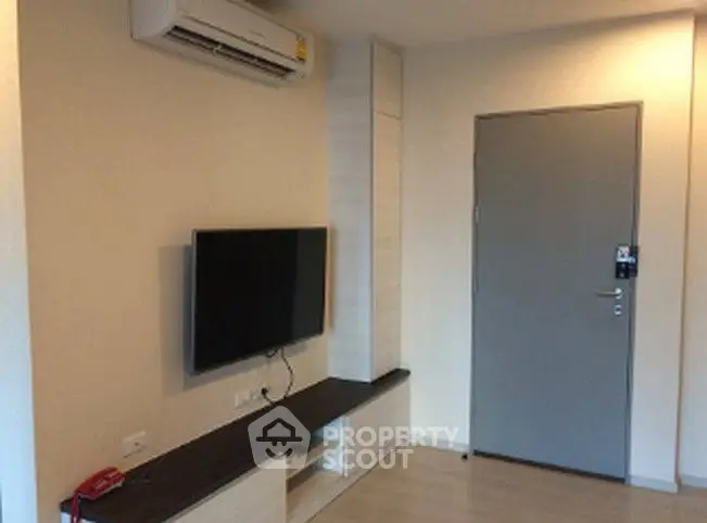 Modern living room with wall-mounted TV and air conditioning unit