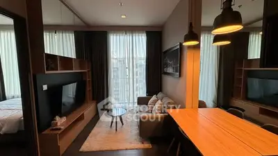 Modern living room with stylish decor and natural light in a contemporary apartment.