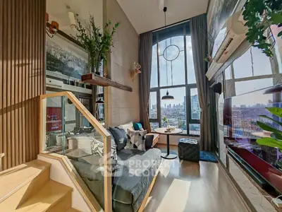 Modern living room with large windows and city view, stylish decor and cozy seating area.