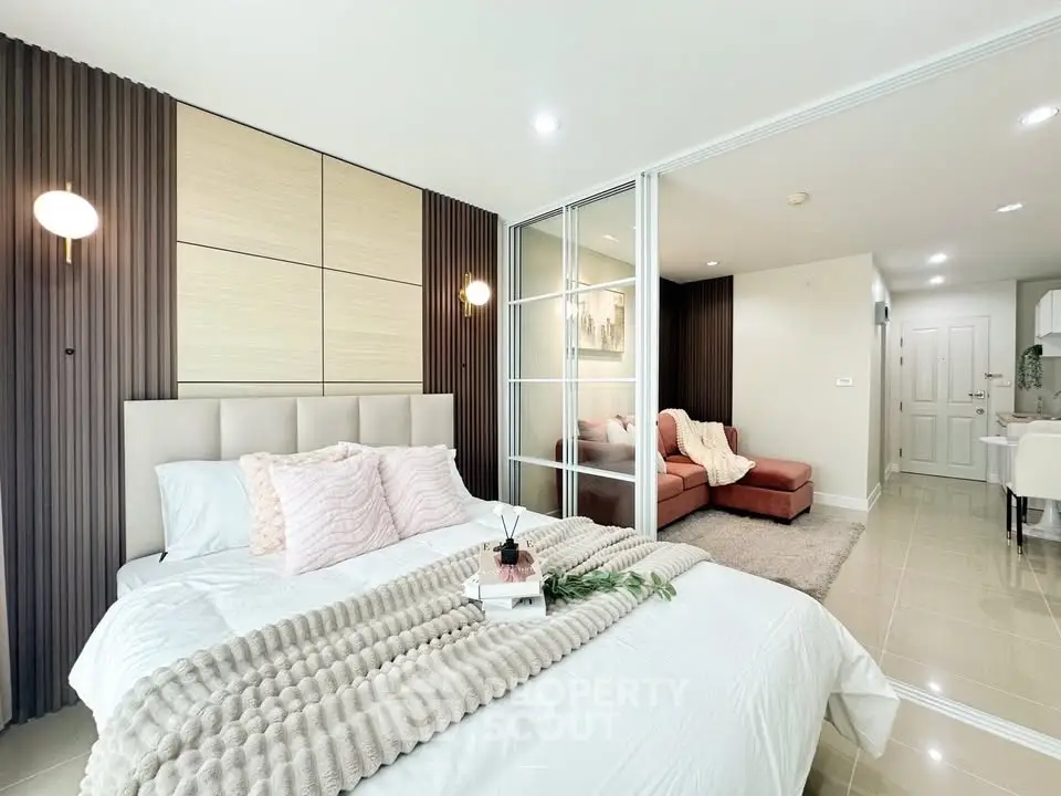 Modern bedroom with cozy decor and open layout to living area