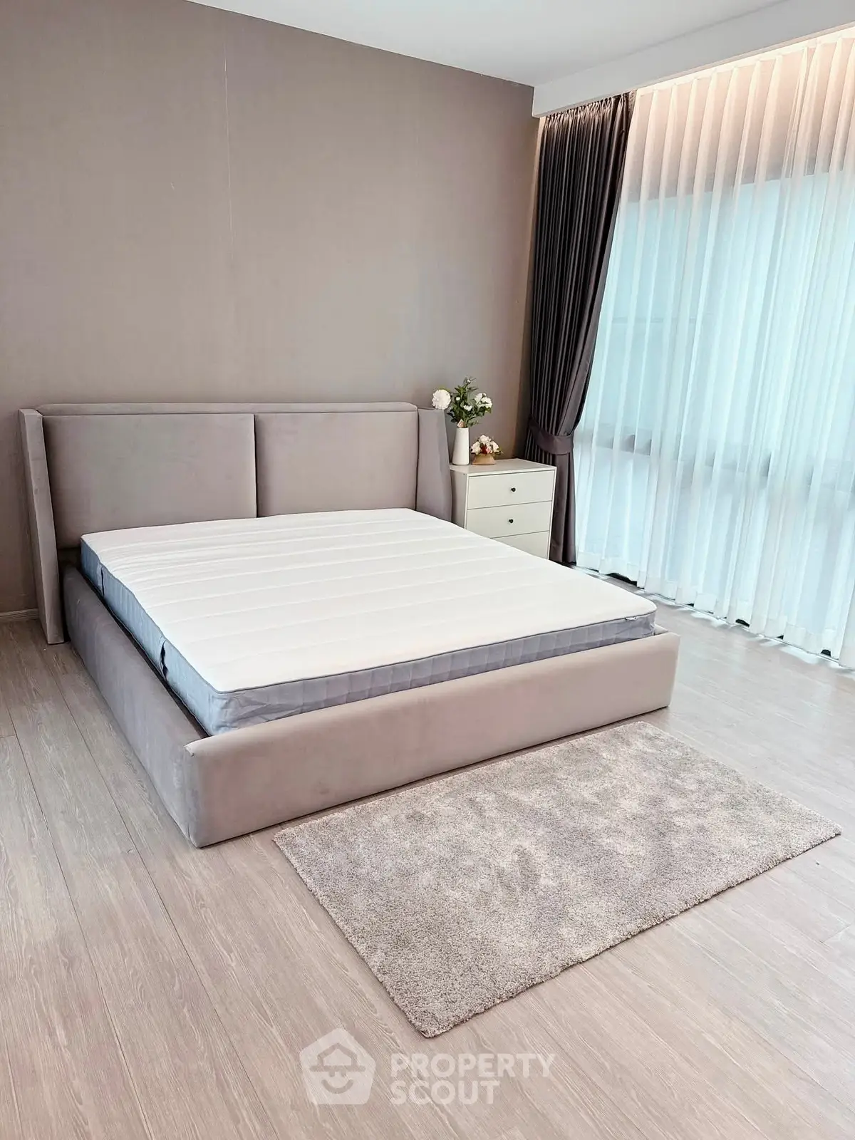 Spacious bedroom with modern design and large windows for natural light.