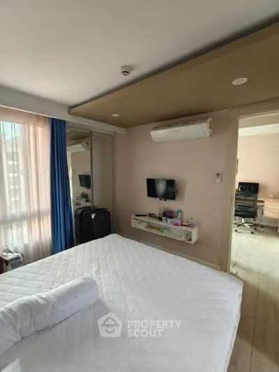 Modern bedroom with air conditioning and wall-mounted TV in a cozy apartment