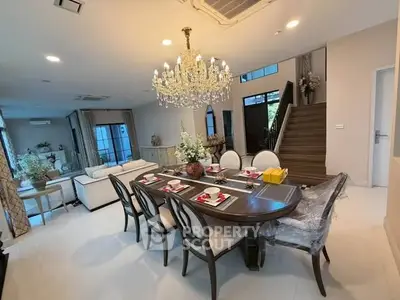 Luxurious dining room with elegant chandelier and spacious seating in modern home