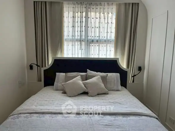 Cozy bedroom with elegant decor and soft lighting, perfect for relaxation.